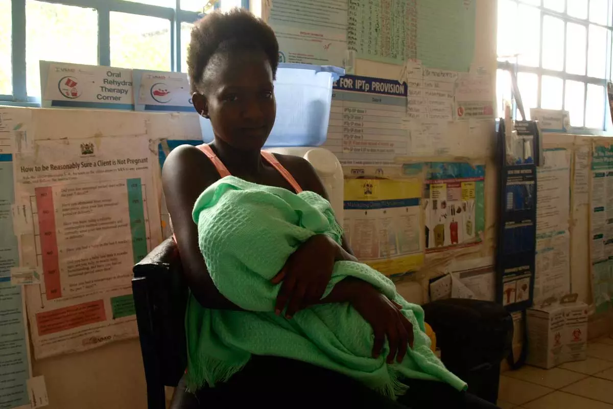 Josephine Opiny, with her baby Matthews, at Tamu Health Centre. Josephine Opiny, with her baby Matthews, at Tamu Health Centre.